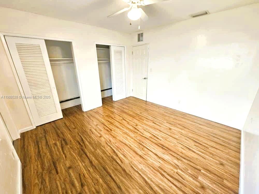 3217 Northeast 7th Place, Unit 1 Pompano Beach, FL 33062 - Photo 19 of 28 a bedroom with a bed and a window