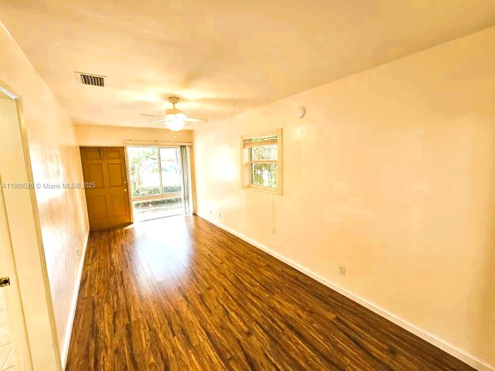 3217 Northeast 7th Place, Unit 1 Pompano Beach, FL 33062 - Photo 20 of 28 a view of empty room with wooden floor and fan