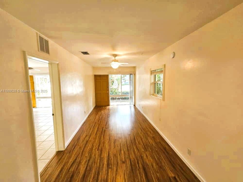 3217 Northeast 7th Place, Unit 1 Pompano Beach, FL 33062 - Photo 21 of 28 a view of a room with wooden floor and balcony