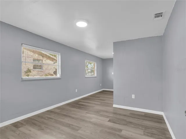a kitchen with sink cabinets and wooden floor