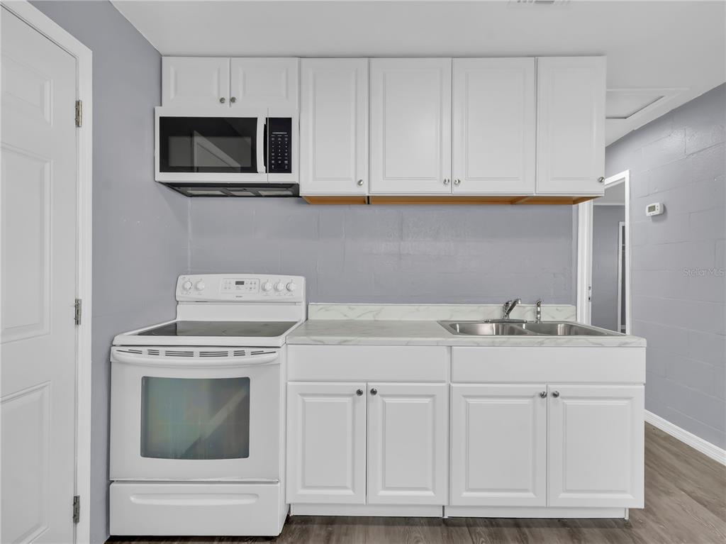 301 Southwest 3rd Terrace Mulberry, FL 33860 - Photo 18 of 39 a kitchen with white cabinets and sink