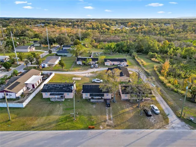 an aerial view of residential houses with outdoor space