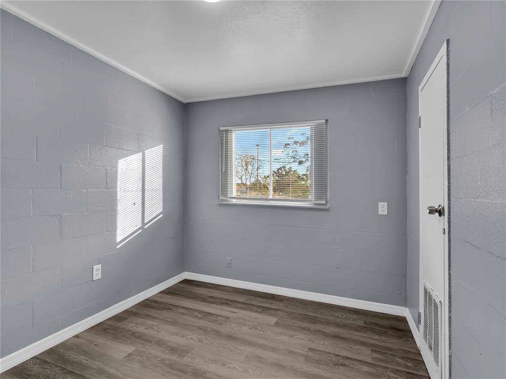 301 Southwest 3rd Terrace Mulberry, FL 33860 - Photo 23 of 39 a view of an empty room with wooden floor and a window