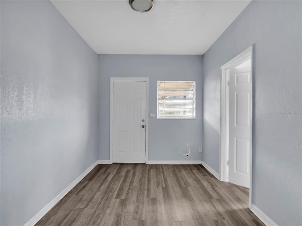 301 Southwest 3rd Terrace Mulberry, FL 33860 - Photo 29 of 39 an empty room with wooden floor and windows