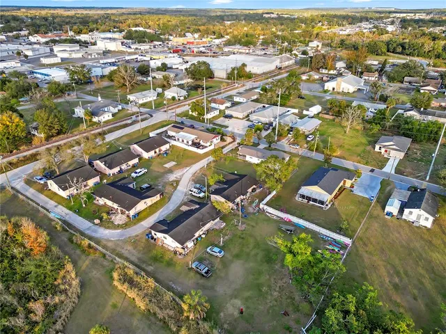 an aerial view of residential houses with outdoor space and swimming pool