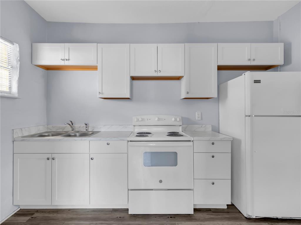 301 Southwest 3rd Terrace Mulberry, FL 33860 - Photo 31 of 39 a kitchen with cabinets appliances a sink and a window