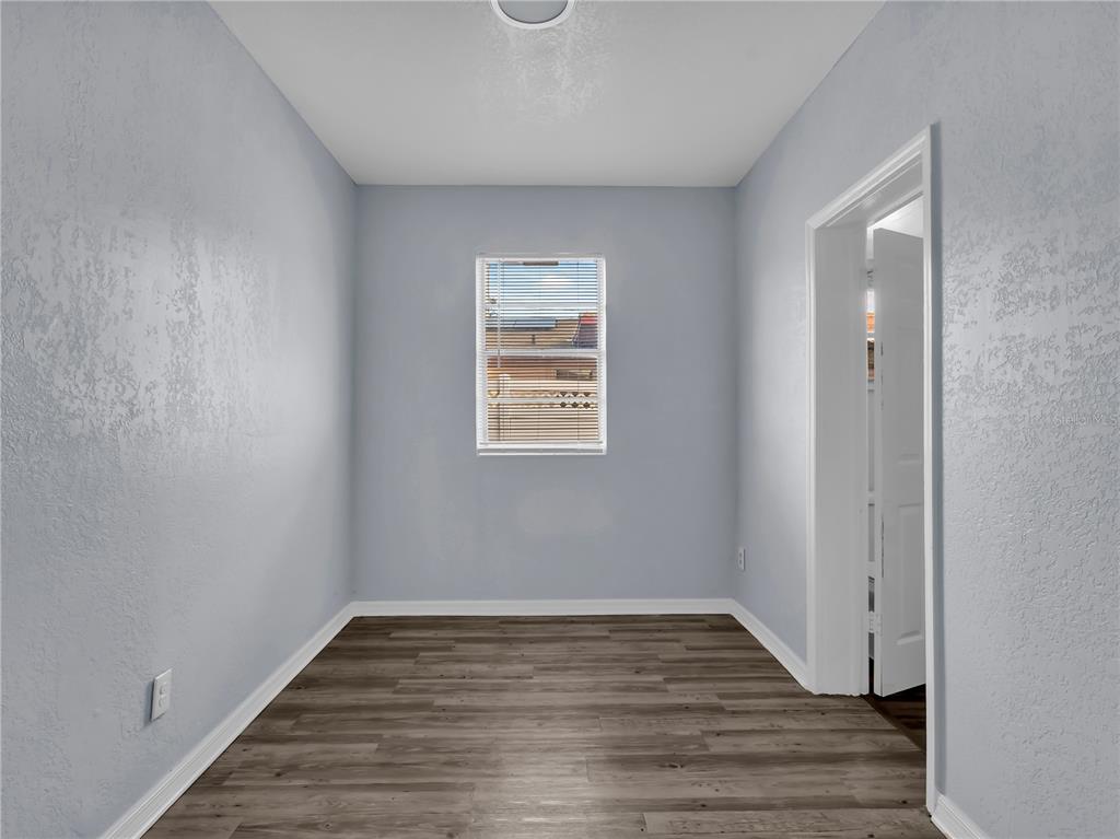 301 Southwest 3rd Terrace Mulberry, FL 33860 - Photo 33 of 39 a view of an empty room with wooden floor and a window