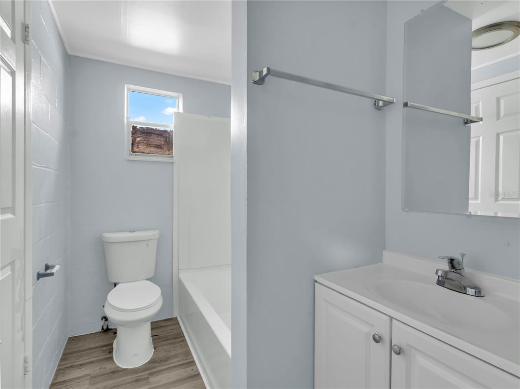 301 Southwest 3rd Terrace Mulberry, FL 33860 - Photo 34 of 39 a bathroom with a toilet sink and mirror