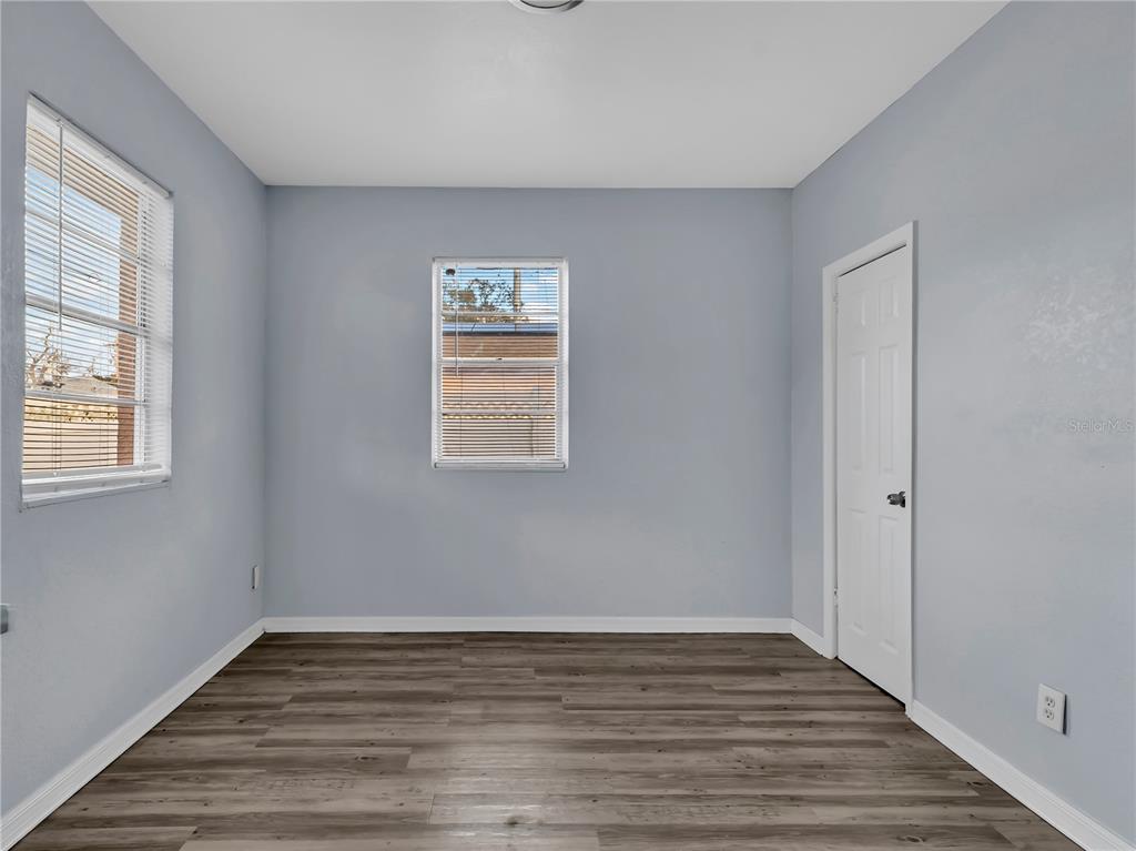 301 Southwest 3rd Terrace Mulberry, FL 33860 - Photo 37 of 39 a view of an empty room with wooden floor and a window