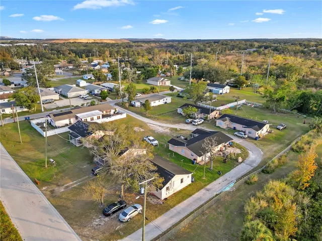 an aerial view of houses with outdoor space