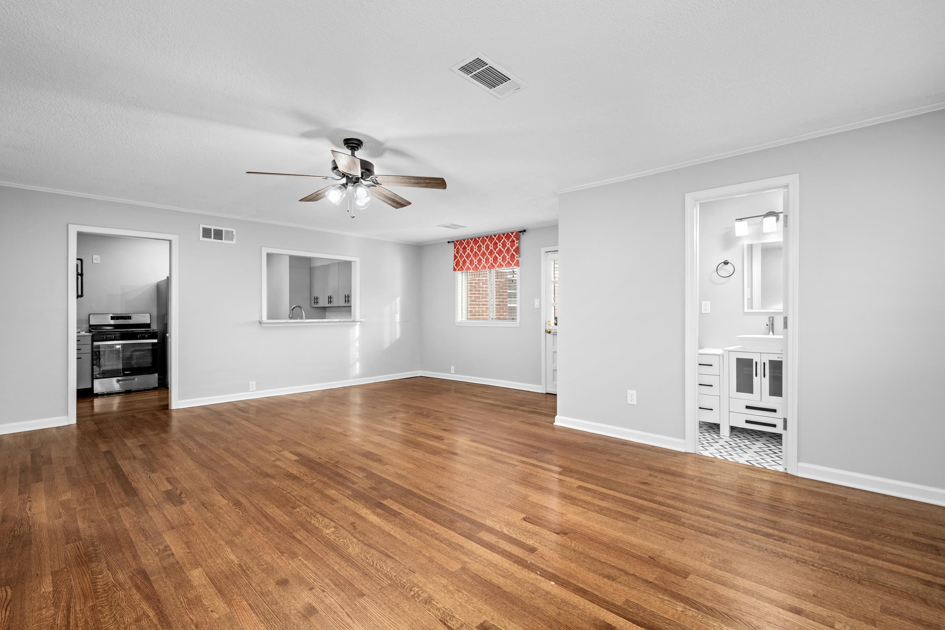 1453 Colonial Road Memphis, TN 38117 - Photo 12 of 36 a view of an empty room with window and wooden floor