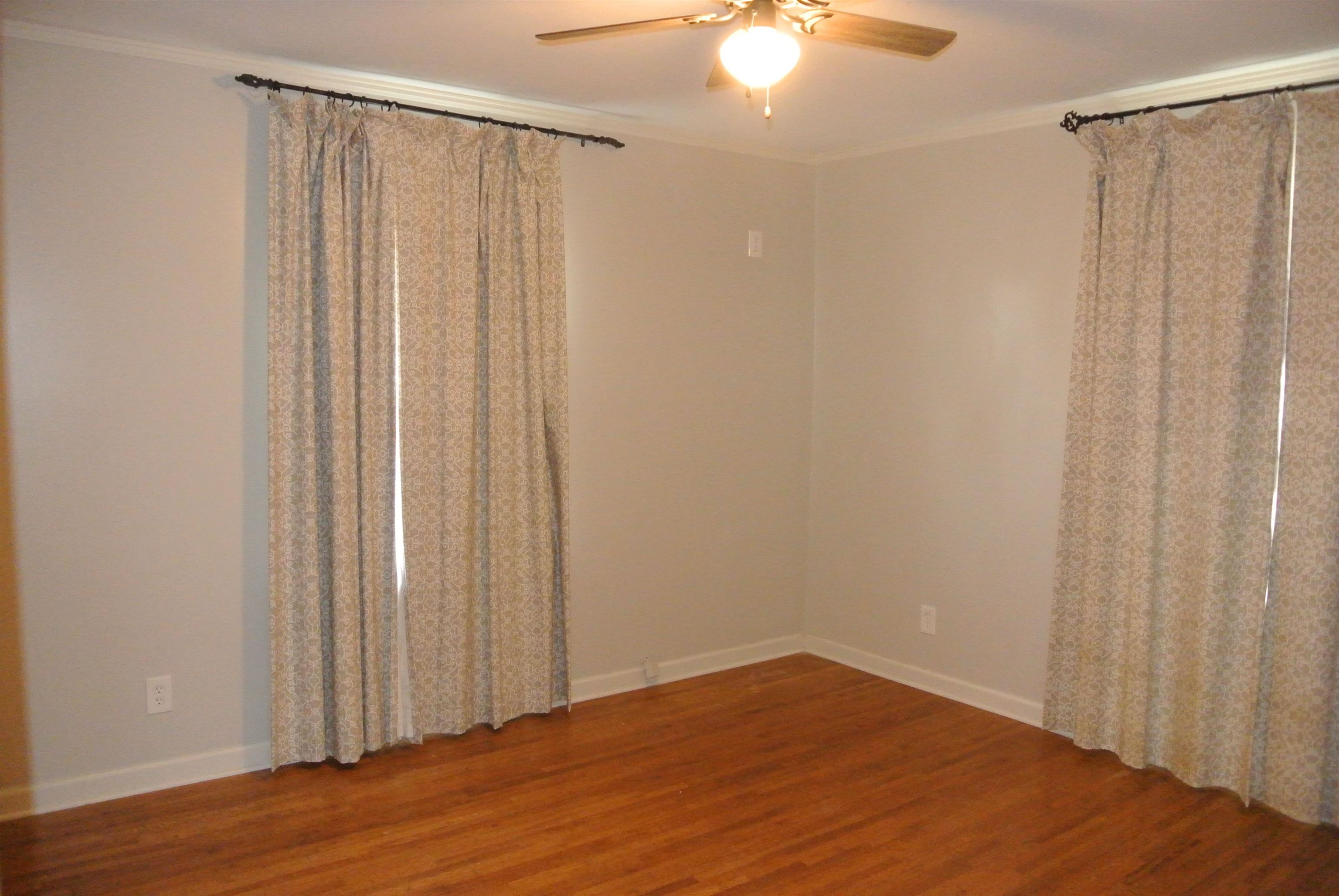 1453 Colonial Road Memphis, TN 38117 - Photo 13 of 19 a view of a livingroom with wooden floor and fan