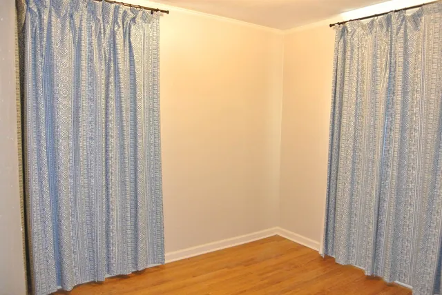 a view of a bathroom with shower curtain