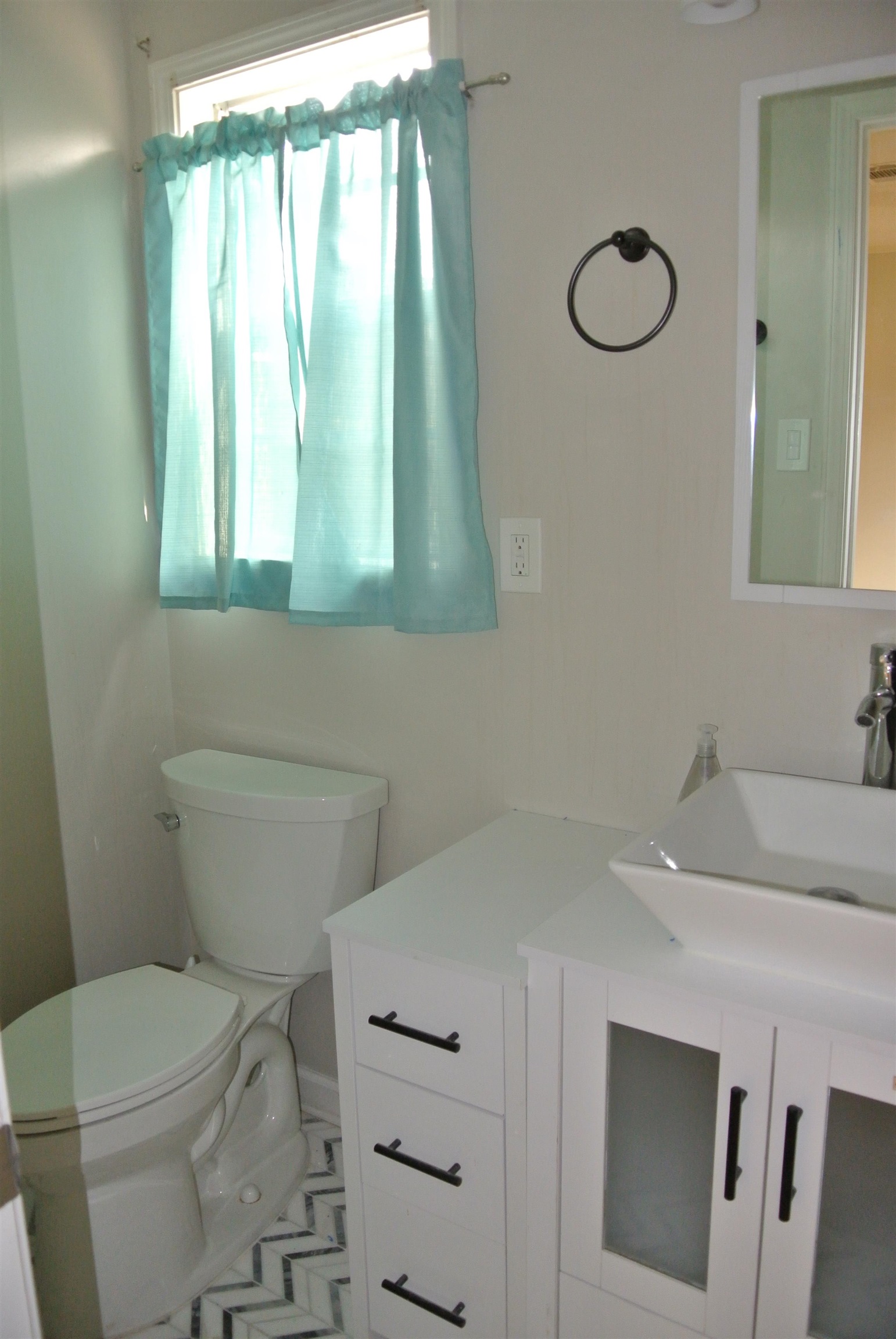 1453 Colonial Road Memphis, TN 38117 - Photo 15 of 19 a bathroom with a sink a toilet and a mirror