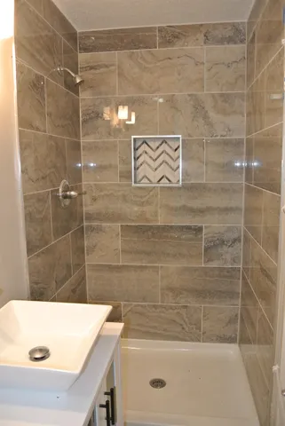 a bathroom with a shower and a sink