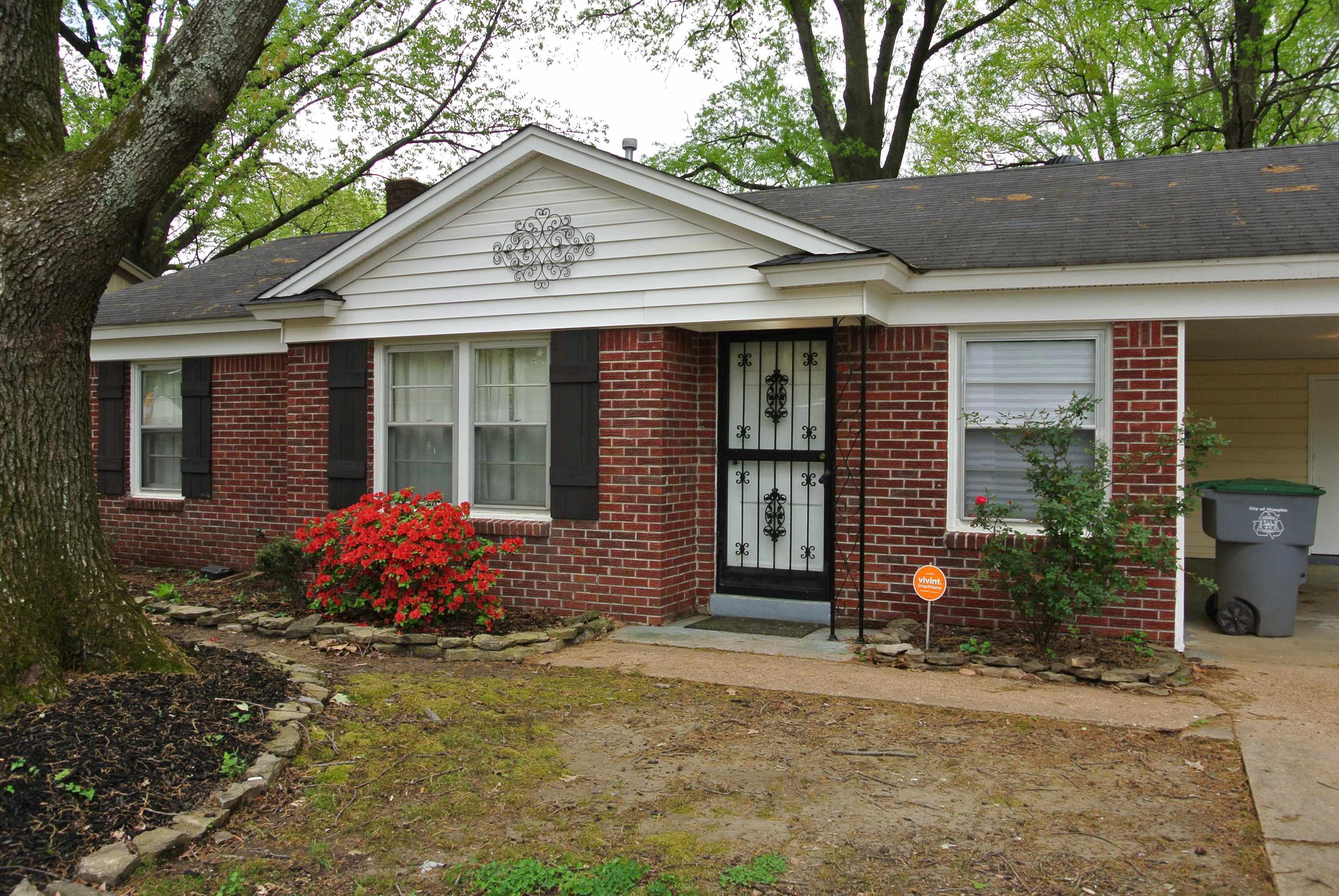1453 Colonial Road Memphis, TN 38117 - Photo 2 of 19 a front view of a house with garden