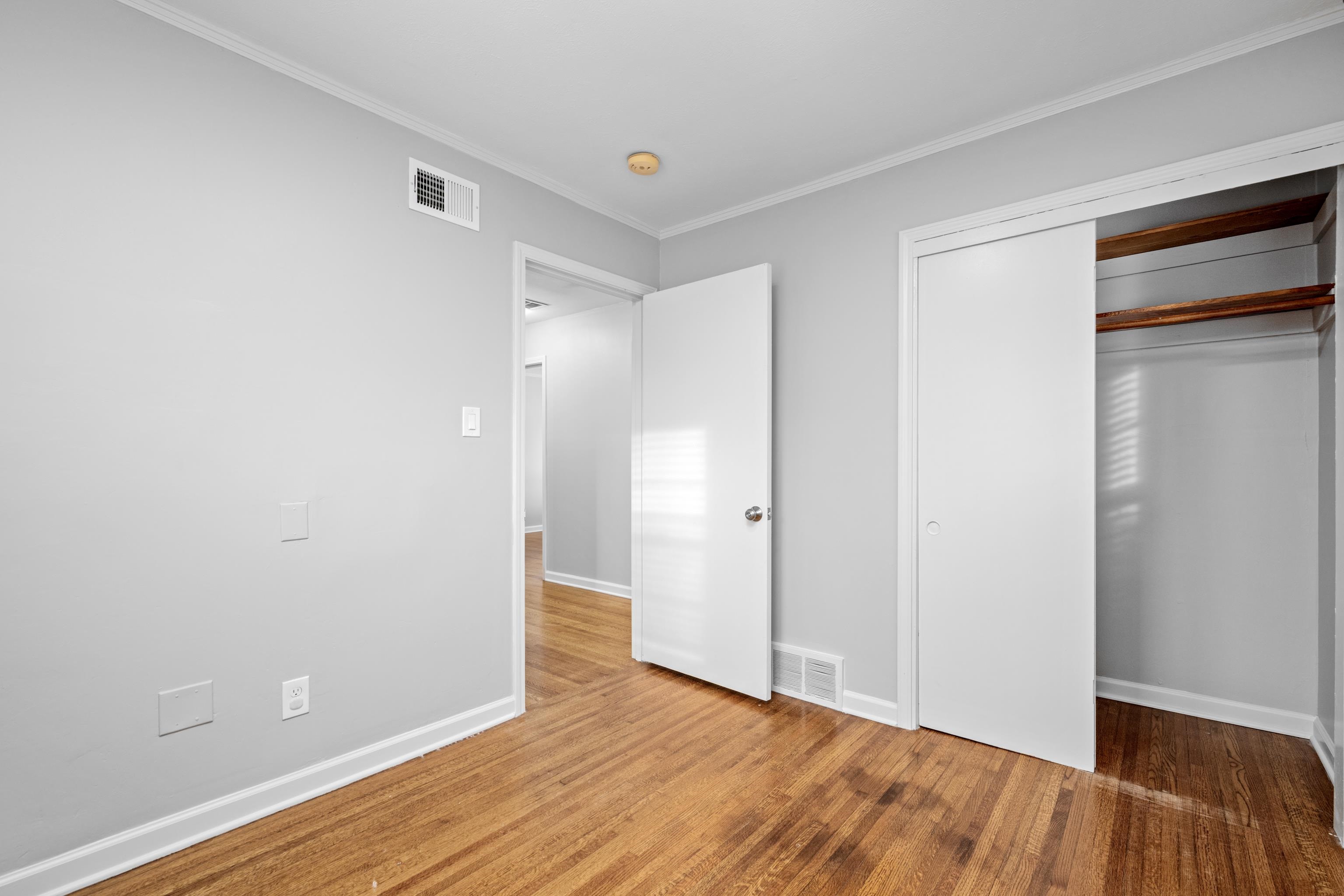1453 Colonial Road Memphis, TN 38117 - Photo 22 of 36 a view of an empty room with wooden floor and closet