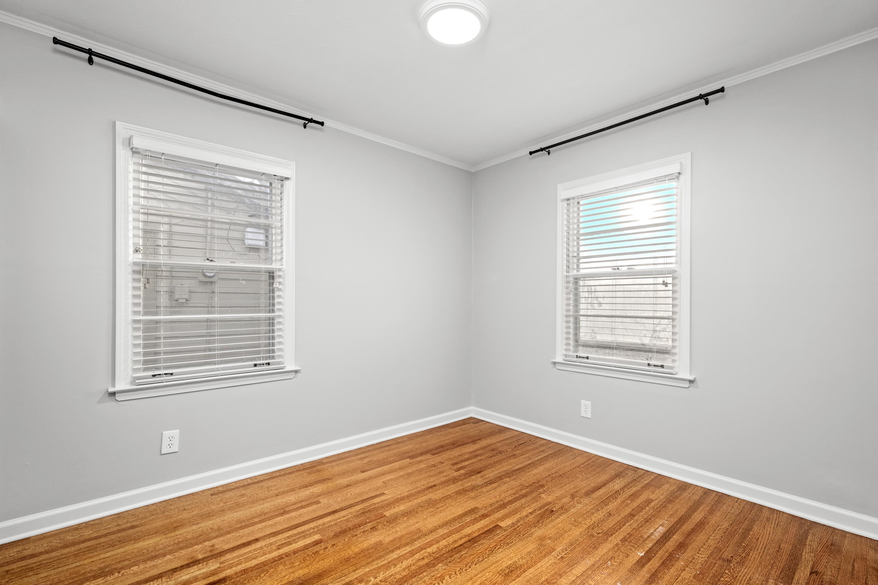1453 Colonial Road Memphis, TN 38117 - Photo 23 of 36 a view of an empty room with wooden floor and a window