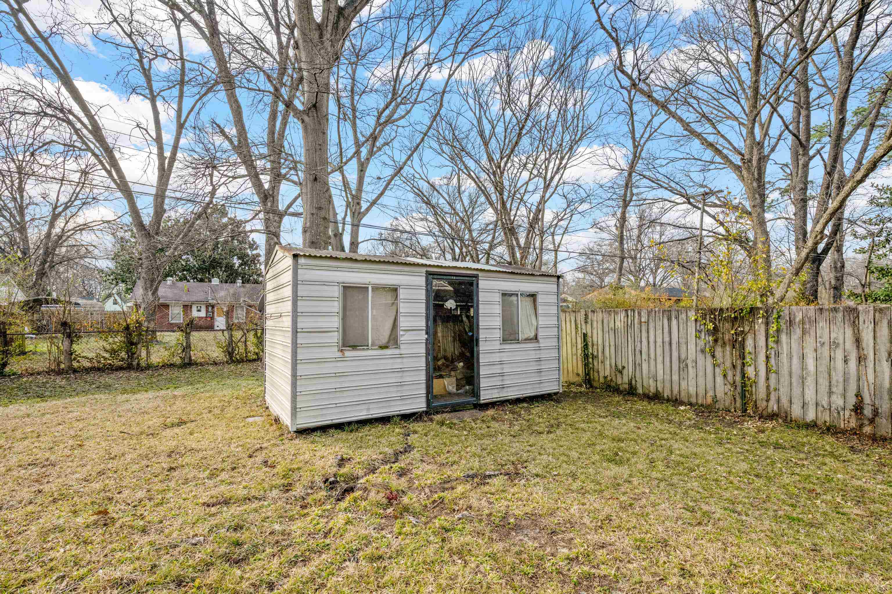 1453 Colonial Road Memphis, TN 38117 - Photo 29 of 36 a view of a house with a large tree and a yard