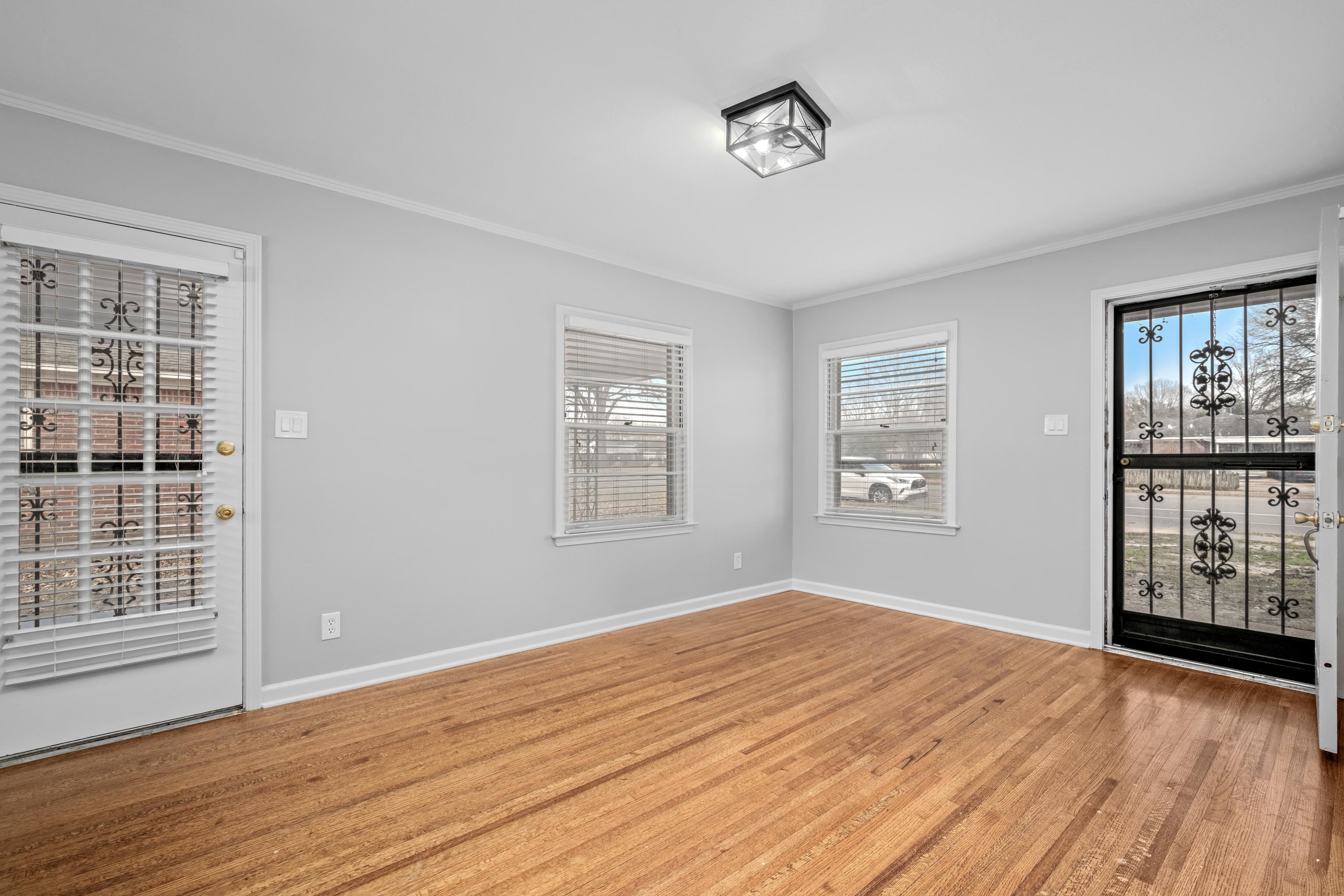 1453 Colonial Road Memphis, TN 38117 - Photo 5 of 36 a view of empty room with wooden floor and fan