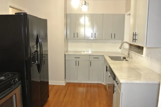 a kitchen with a sink a refrigerator a stove and a cabinets