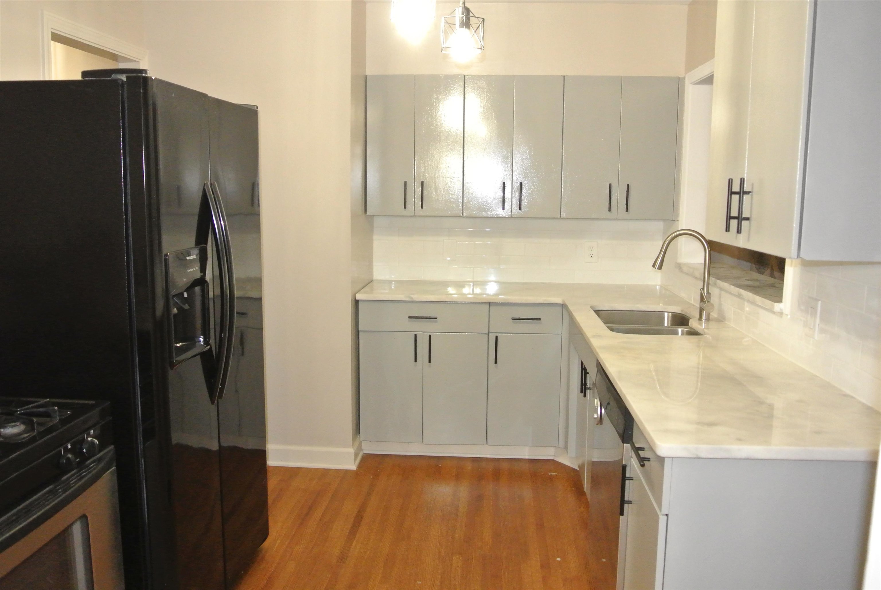 1453 Colonial Road Memphis, TN 38117 - Photo 5 of 19 a kitchen with a sink a refrigerator a stove and a cabinets