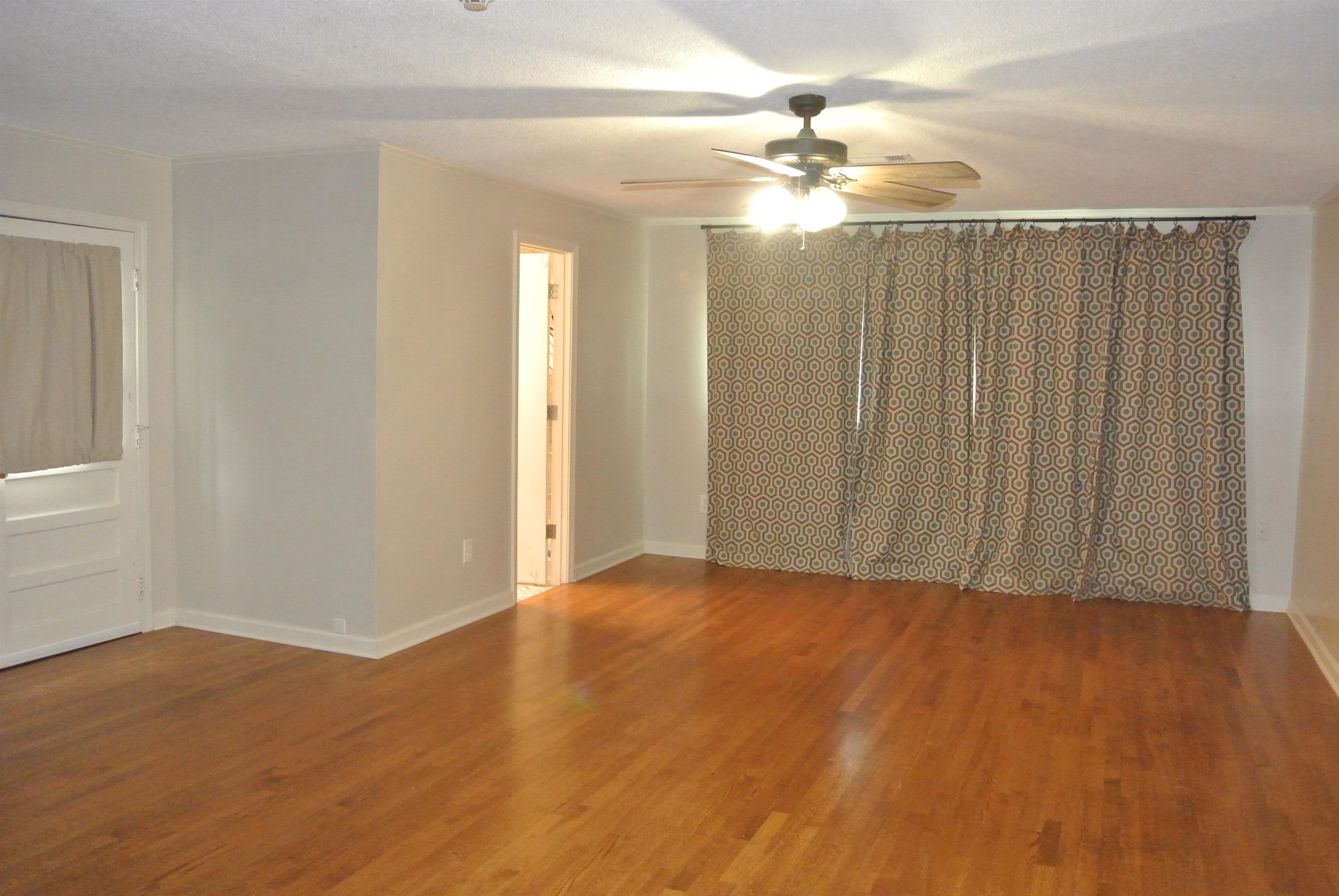 1453 Colonial Road Memphis, TN 38117 - Photo 7 of 19 a view of a room with wooden floor and fan