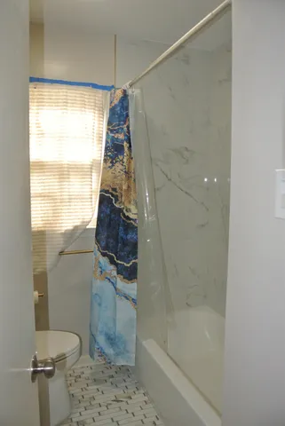 a bathroom with a bathtub and a shower