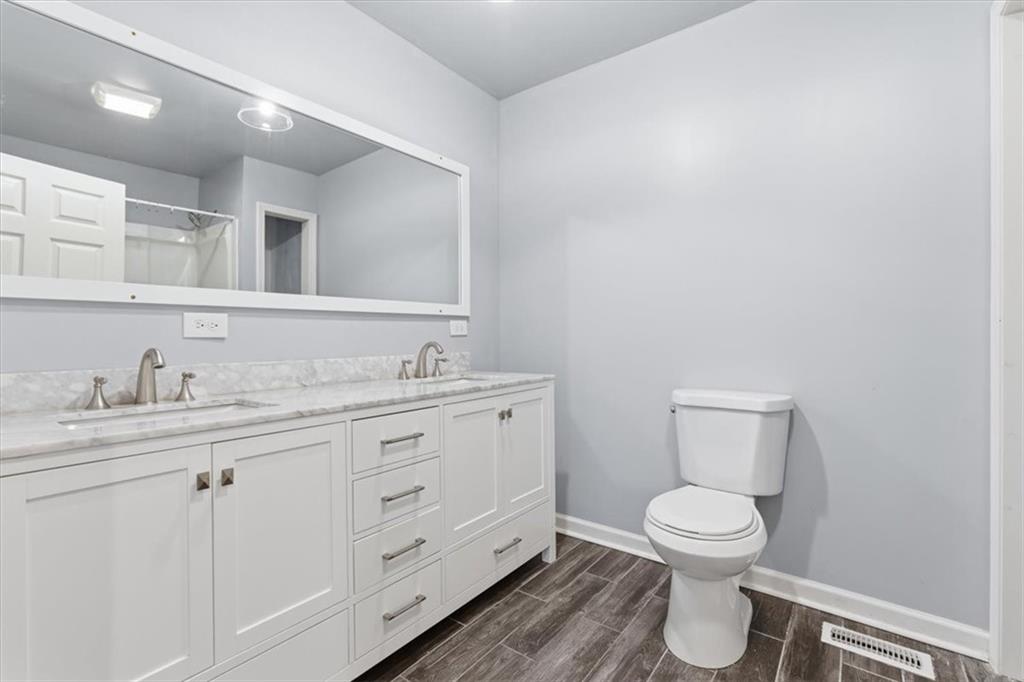 1500 Moores Ferry Road Southwest Plainville, GA 30733 - Photo 29 of 33 a bathroom with a granite countertop toilet sink and mirror