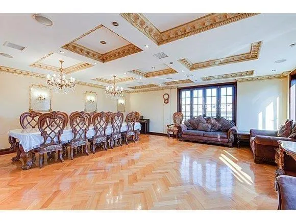 a living room with lots of furniture and a large mirror