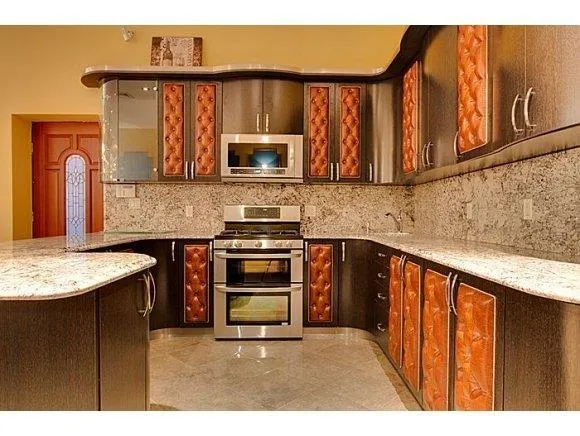 a kitchen with stainless steel appliances granite countertop a stove top oven a sink and dishwasher