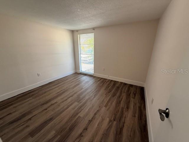 600 Russell Street Longboat Key, FL 34228 - Photo 11 of 13 a view of an empty room with wooden floor and a window