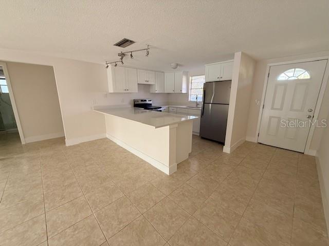 600 Russell Street Longboat Key, FL 34228 - Photo 3 of 13 a large kitchen with cabinets and stainless steel appliances