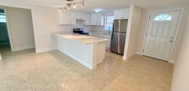 600 Russell Street Longboat Key, FL 34228 - Photo 5 of 13 a kitchen with a refrigerator a stove top oven and a refrigerator
