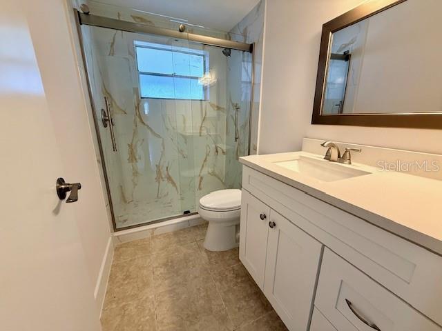 600 Russell Street Longboat Key, FL 34228 - Photo 7 of 13 a bathroom with a sink a toilet a mirror and shower