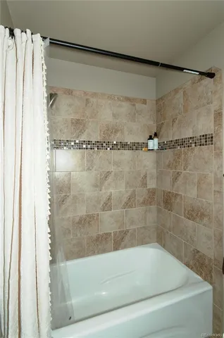 a bathroom with a shower and a bath tub