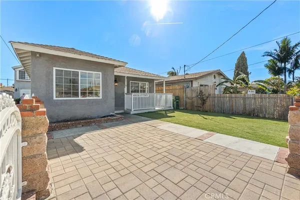 a backyard of a house with wooden fence