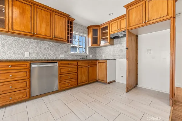 a kitchen with stainless steel appliances granite countertop a sink and cabinets