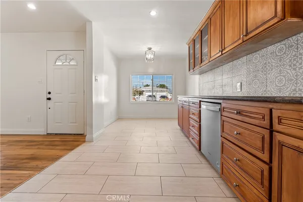 a kitchen with stainless steel appliances granite countertop a refrigerator and a stove