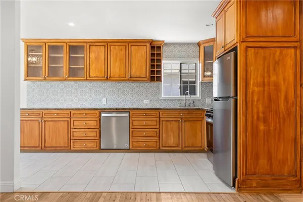 a kitchen with stainless steel appliances granite countertop a refrigerator and a stove