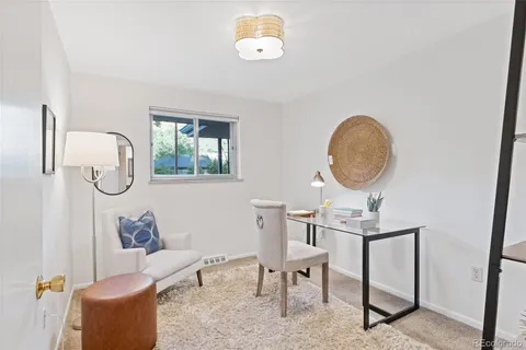 a living room with furniture a mirror and a window