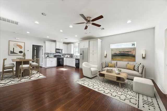 a living room with furniture and kitchen view
