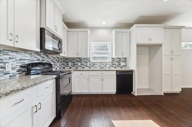 a kitchen with a sink stove and cabinets