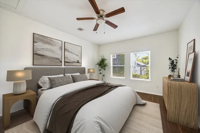 a bedroom with a large bed and a window