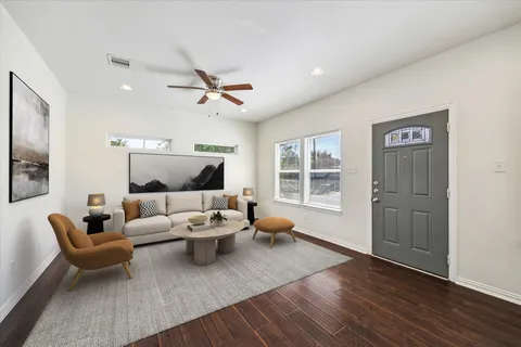 a living room with furniture and wooden floor