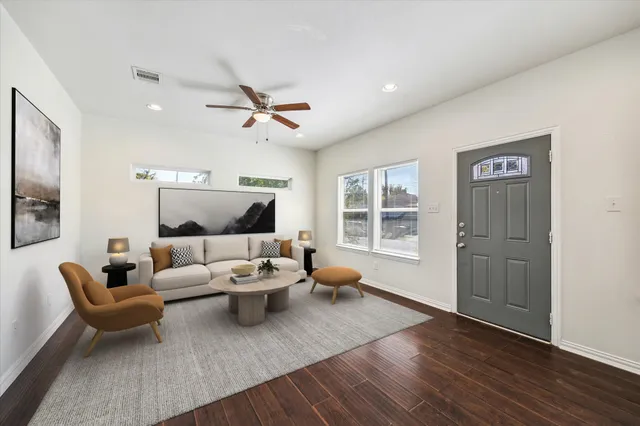 a living room with furniture and wooden floor