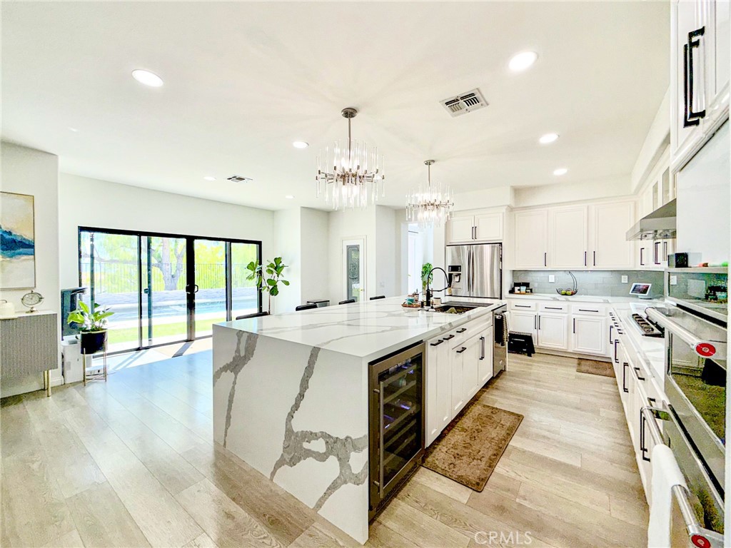25714 Wallace Place Stevenson Ranch, CA 91381 - Photo 2 of 24 a large white kitchen with a large window