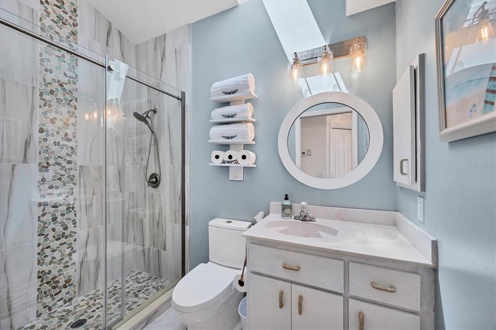 11 Amberjack Lane Placida, FL 33946 - Photo 14 of 46 a bathroom with a granite countertop sink toilet a mirror a vanity and shower