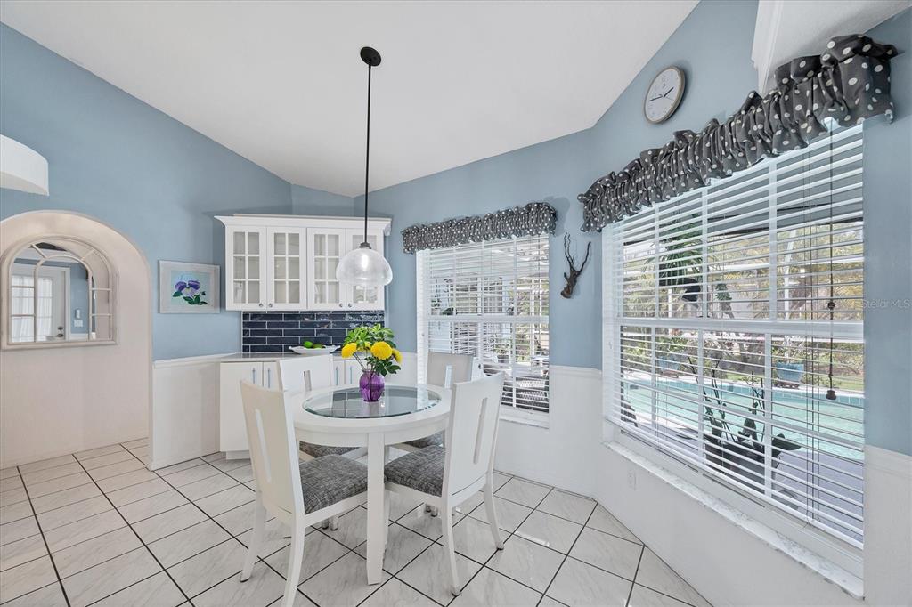 11 Amberjack Lane Placida, FL 33946 - Photo 19 of 46 a kitchen with stainless steel appliances kitchen island granite countertop a refrigerator a stove a dining table and chairs with wooden floor