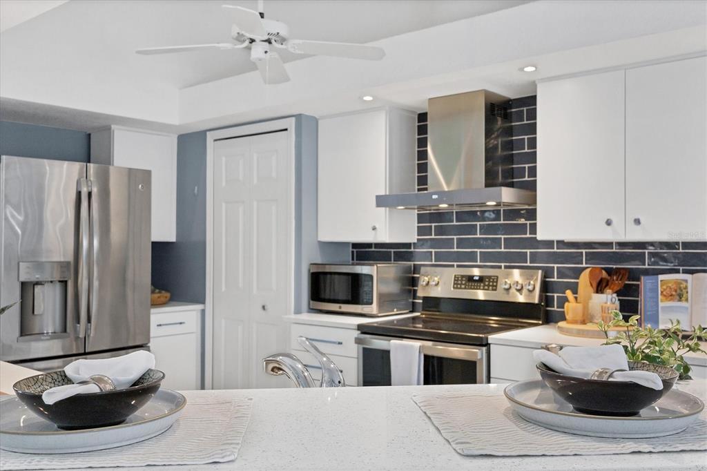 11 Amberjack Lane Placida, FL 33946 - Photo 30 of 46 a kitchen with stainless steel appliances kitchen island granite countertop a refrigerator and a stove top oven